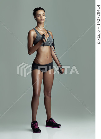 Fitness, music and skipping rope with portrait of woman in studio isolated on gray background. Exercise, equipment and workout with serious athlete training for challenge, health or performance Fitness, music and skipping rope with portrait of woman in studio isolated on gray background. Exercise, equipment and workout with serious athlete training for challenge, health or performance 142729414