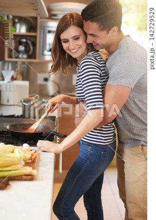 Home, couple and hug with cooking, smile and break together with happiness and love. Kitchen, lunch and man with woman, relationship embrace and romance for nutrition and marriage support for meal Home, couple and hug with cooking, smile and break together with happiness and love. Kitchen, lunch and man with woman, relationship embrace and romance for nutrition and marriage support for meal 142729529