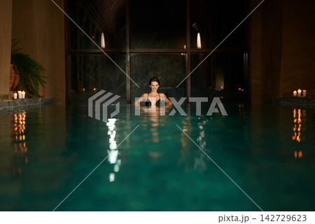 Dark, pool and relax for woman in resort, calm and hotel or accommodation for holiday or vacation travel. Luxury, water and freedom for wellness and night for female person, spa and salon treatment Dark, pool and relax for woman in resort, calm and hotel or accommodation for holiday or vacation travel. Luxury, water and freedom for wellness and night for female person, spa and salon treatment 142729623