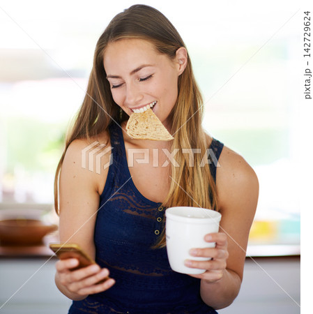 Woman, cellphone and toast with coffee in morning, breakfast and nutrition with news. Technology, food and current affairs online on smartphone, social media and female person in home kitchen Woman, cellphone and toast with coffee in morning, breakfast and nutrition with news. Technology, food and current affairs online on smartphone, social media and female person in home kitchen 142729624