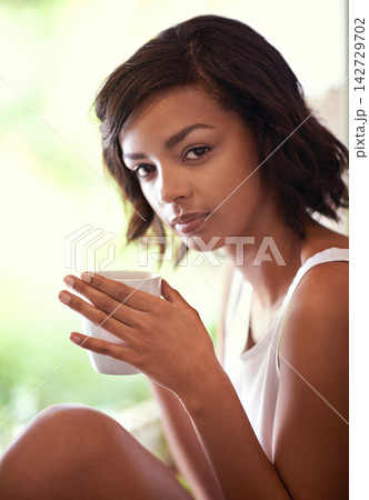 Woman, portrait and serious in morning with coffee or tea with relax in pyjamas on weekend with pride. Apartment, confidence and coco or hot chocolate with self care in house in Sweden with mug Woman, portrait and serious in morning with coffee or tea with relax in pyjamas on weekend with pride. Apartment, confidence and coco or hot chocolate with self care in house in Sweden with mug 142729702