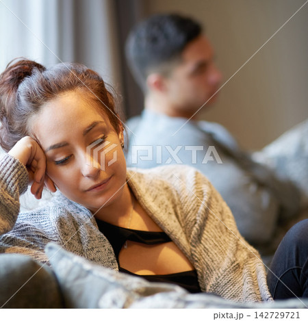 Argument, breakup and sad with couple on sofa in living room of home for conflict or depression. Angry, anxiety or cross and woman upset with man in apartment for divorce, family law or fighting 142729721