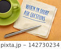 When in Doubt, Ask Questions. Inspirational handwritten message on a napkin with coffee and pen, encouraging curiosity, critical thinking, learning, and better decisions. 142730234