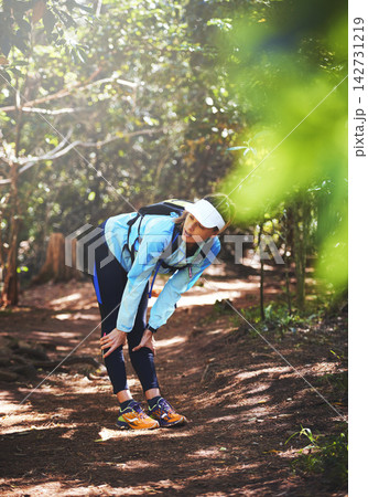 Break, runner and tired woman hiking in nature on trail or outdoor adventure to explore on holiday vacation. Girl, rest or hiker trekking in woods for running training, fitness or travel with fatigue Break, runner and tired woman hiking in nature on trail or outdoor adventure to explore on holiday vacation. Girl, rest or hiker trekking in woods for running training, fitness or travel with fatigue 142731219