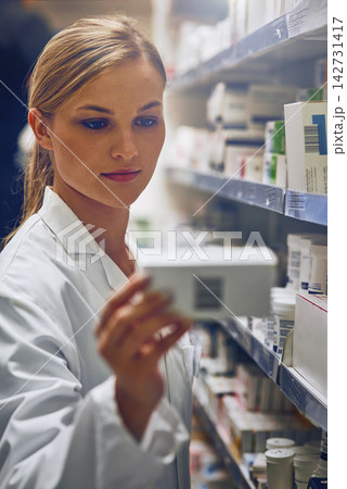 Reading, label and woman in pharmacy with drugs, pills or search for prescription medicine inventory. Pharmacist, working and sale at shop with choice of medical product for healing or healthcare Reading, label and woman in pharmacy with drugs, pills or search for prescription medicine inventory. Pharmacist, working and sale at shop with choice of medical product for healing or healthcare 142731417