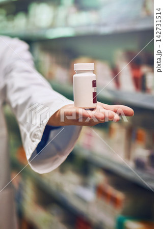 Pharmacist, hand and bottle for pills in store with by shelf for stock, show and inventory for wellness. Person, employee and container with pharmaceutical, review and presentation for drugs at shop Pharmacist, hand and bottle for pills in store with by shelf for stock, show and inventory for wellness. Person, employee and container with pharmaceutical, review and presentation for drugs at shop 142731514