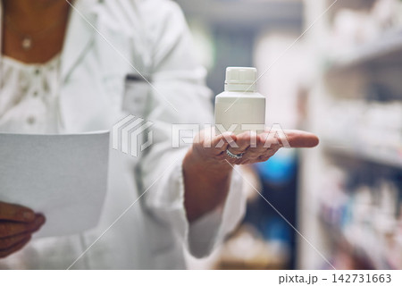 Pharmacist, hand and bottle for drugs in store by shelf for document, show and inventory for health. Person, employee and container with prescription, review or advertising for medical pills at shop Pharmacist, hand and bottle for drugs in store by shelf for document, show and inventory for health. Person, employee and container with prescription, review or advertising for medical pills at shop 142731663