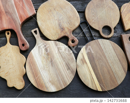 Collection of Wooden Serving Boards on Dark Wood Collection of Wooden Serving Boards on Dark Wood 142731688
