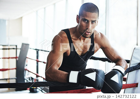 Latino man, boxer and portrait for fitness, exercise or training workout ready for fight at gym. Professional fighter, boxing and competitive sports for ring match, health and wellness with endurance Latino man, boxer and portrait for fitness, exercise or training workout ready for fight at gym. Professional fighter, boxing and competitive sports for ring match, health and wellness with endurance 142732122