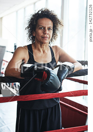 Mature woman, boxer and portrait for training, exercise or fitness workout ready for fight at gym. Female fighter, boxing and competitive sports for ring match, health and wellness with endurance Mature woman, boxer and portrait for training, exercise or fitness workout ready for fight at gym. Female fighter, boxing and competitive sports for ring match, health and wellness with endurance 142732126