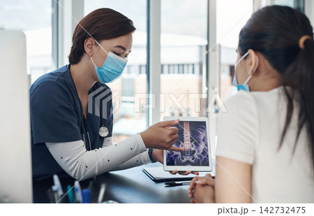 Nurse, screen and tablet with x ray in hospital for bone tumor, infection and spine fracture results. Healthcare, medical worker and patient for consultation with digital diagnosis, face mask or talk Nurse, screen and tablet with x ray in hospital for bone tumor, infection and spine fracture results. Healthcare, medical worker and patient for consultation with digital diagnosis, face mask or talk 142732475