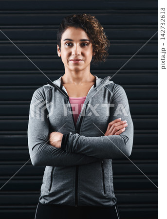 Fitness, crossed arms and portrait of woman athlete with confidence for workout, weightloss or training. Smile, pride and Mexican female person with wellness, health and body exercise by garage door. Fitness, crossed arms and portrait of woman athlete with confidence for workout, weightloss or training. Smile, pride and Mexican female person with wellness, health and body exercise by garage door. 142732618