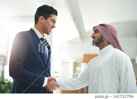 Arab, business and people with hand shake in office, recruitment and muslim employee for greeting. B2b partnership, collaboration and congratulation gesture for deal, islam company and onboarding Arab, business and people with hand shake in office, recruitment and muslim employee for greeting. B2b partnership, collaboration and congratulation gesture for deal, islam company and onboarding 142732706