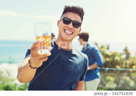 Man, toast and smile with sunglasses at party on balcony with celebration on holiday in summer. Person, happy and glass of beer at with cheers, drink and outdoor at social club for event in sunshine 142732839