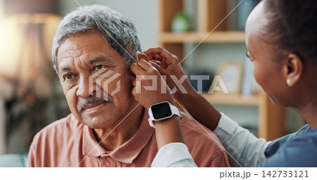 Nurse, patient and hearing aid on ear for medical support, wellness or innovation of disability. People, healthcare worker or deaf man with audiology implant, check and service or help for sound wave 142733121