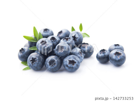 Blueberries with leaves on white background Blueberries with leaves on white background 142733253