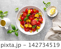 Salad with fresh sweet corn, cherry tomatoes, basil and olive oil 142734519