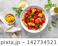 Salad with fresh sweet corn, cherry tomatoes, basil and olive oil 142734521