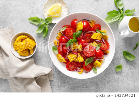 Salad with fresh sweet corn, cherry tomatoes, basil and olive oil Salad with fresh sweet corn, cherry tomatoes, basil and olive oil 142734521