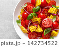 Salad with fresh sweet corn, cherry tomatoes, basil and olive oil 142734522