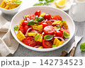 Salad with fresh sweet corn, cherry tomatoes, basil and olive oil 142734523