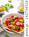 Salad with fresh sweet corn, cherry tomatoes, basil and olive oil 142734524