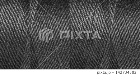 Close-up texture of Black sewing threads on a spool 142734582