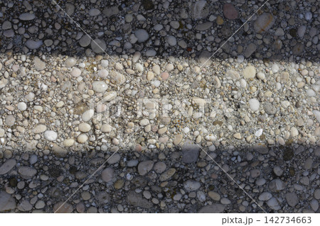 Sunlight on concrete pebbles 142734663