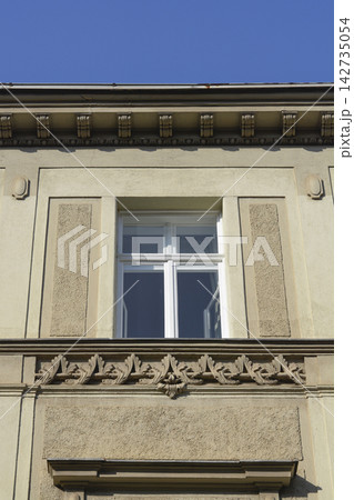 Classical building facade with ornate window detail Classical building facade with ornate window detail 142735054