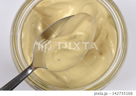Homemade creamy mayonnaise on a metal spoon Homemade creamy mayonnaise on a metal spoon 142735108