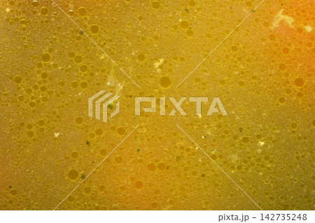 Golden chicken soup texture with oil bubbles 142735248