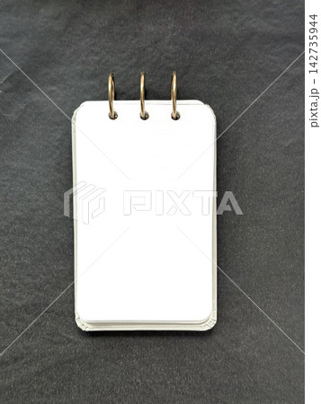Blank White Ring Notebook on Dark Textured Background 142735944