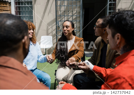 Diverse group holding hands in support circle Diverse group holding hands in support circle 142737042