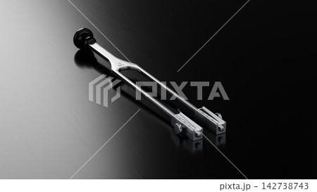 Premium Medical Tuning Fork C128 Hz on Brushed Dark Metallic Surface 142738743