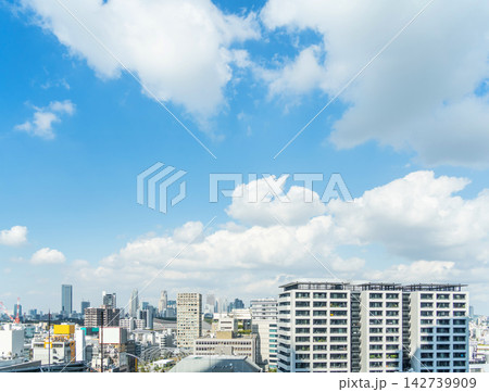 Cityscape and skyline of shibuya in tokyo japan under bright blue sky with white clouds and copy space Cityscape and skyline of shibuya in tokyo japan under bright blue sky with white clouds and copy space 142739909