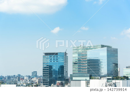 Cityscape and skyline of shibuya in tokyo japan under bright blue sky with white clouds and copy space Cityscape and skyline of shibuya in tokyo japan under bright blue sky with white clouds and copy space 142739914