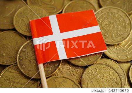 Denmark flag on coins background, finance and accounting, banking concept. Denmark flag on coins background, finance and accounting, banking concept. 142743670