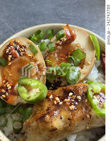 Soy marinated eggs or served with warm white rice, featuring glossy yolks and rich savory flavor. A comforting Korean dish that feels simple, addictive, and deeply satisfying. 142743789