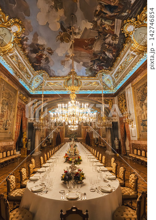 Elegant palace dining hall set for a formal banquet with crystal chandeliers 142746854