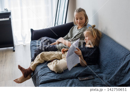 Pretty sibling learning a role for the school drama club at home 142750651