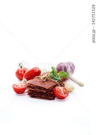 Savory tomato pastila with fresh basil on white background 142751529