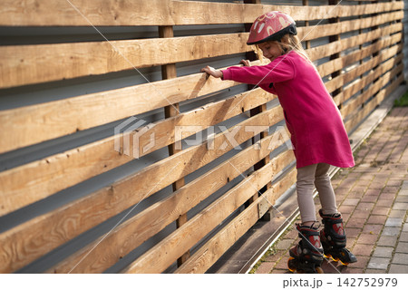 Young Girl Learning New Skill Outdoors, Practicing Roller Skating, Confidence Building, Achievement And Happy Childhood Concept. Copy Space Young Girl Learning New Skill Outdoors, Practicing Roller Skating, Confidence Building, Achievement And Happy Childhood Concept. Copy Space 142752979