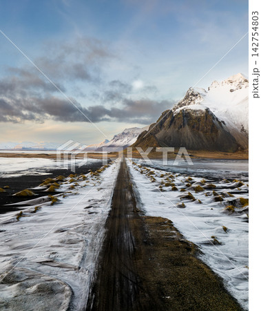 Snow-covered Vestrahorn mountain and icy landscape at Stokksnes beach, South East Iceland Snow-covered Vestrahorn mountain and icy landscape at Stokksnes beach, South East Iceland 142754803