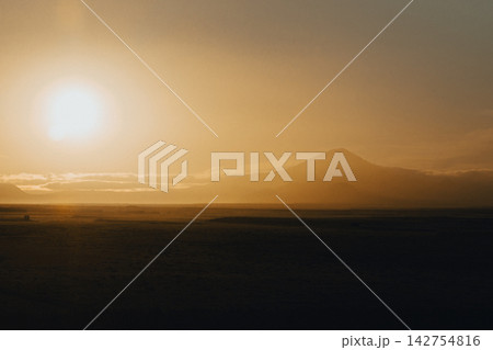 Golden sunrise over Hekla volcano in South Iceland, creating a serene landscape. Golden sunrise over Hekla volcano in South Iceland, creating a serene landscape. 142754816