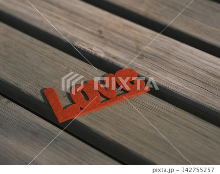 red decorative love lettering on wooden board red decorative love lettering on wooden board 142755257