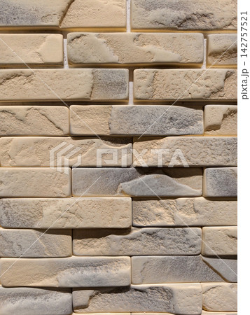 Decorative cladding panels replicating brick stone and tile textures shown in a construction store aisle for practical finishing and renovation applications Decorative cladding panels replicating brick stone and tile textures shown in a construction store aisle for practical finishing and renovation applications 142757521