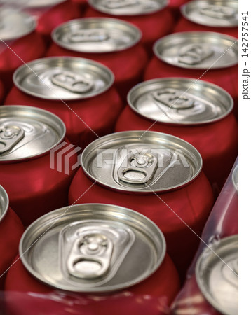 Red aluminum soda cans grouped in factory packaging showcasing organized beverage manufacturing logistics product preparation and supply chain operations 142757541