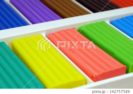 Assorted colored plasticine perfect for skillful hands to model, shape, and craft unique designs Assorted colored plasticine perfect for skillful hands to model, shape, and craft unique designs 142757589