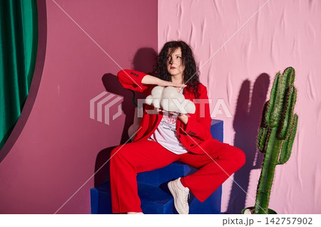 Charismatic host in colorful setting speaks confidently Charismatic host in colorful setting speaks confidently 142757902