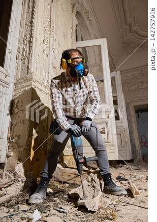 Skilled craftsman restoring vintage mansion amid debris and dust Skilled craftsman restoring vintage mansion amid debris and dust 142757916